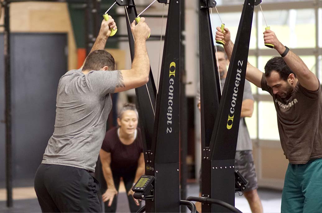 People on SkiErg competing