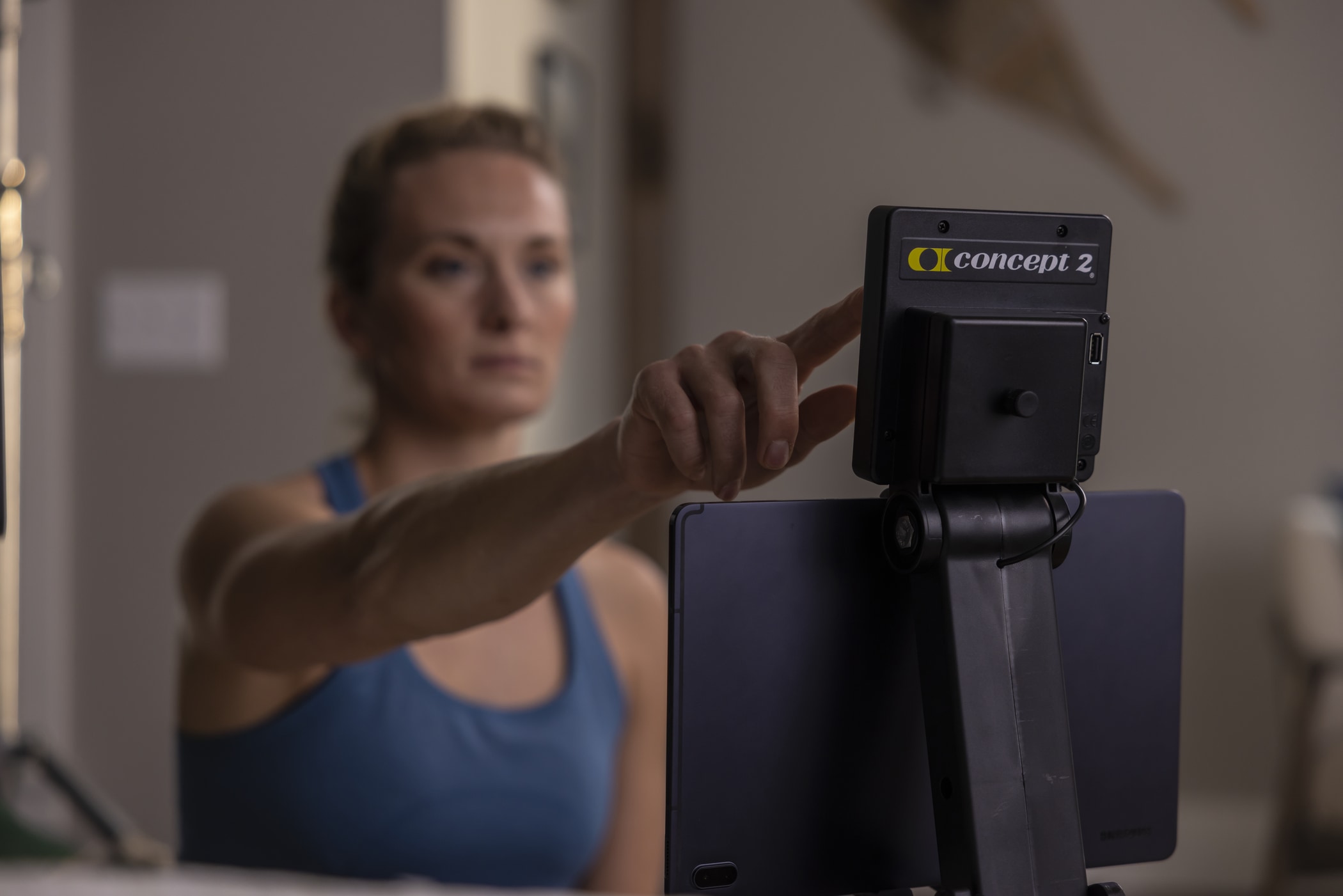 Woman using a PM5 monitor on a Concept2 RowErg