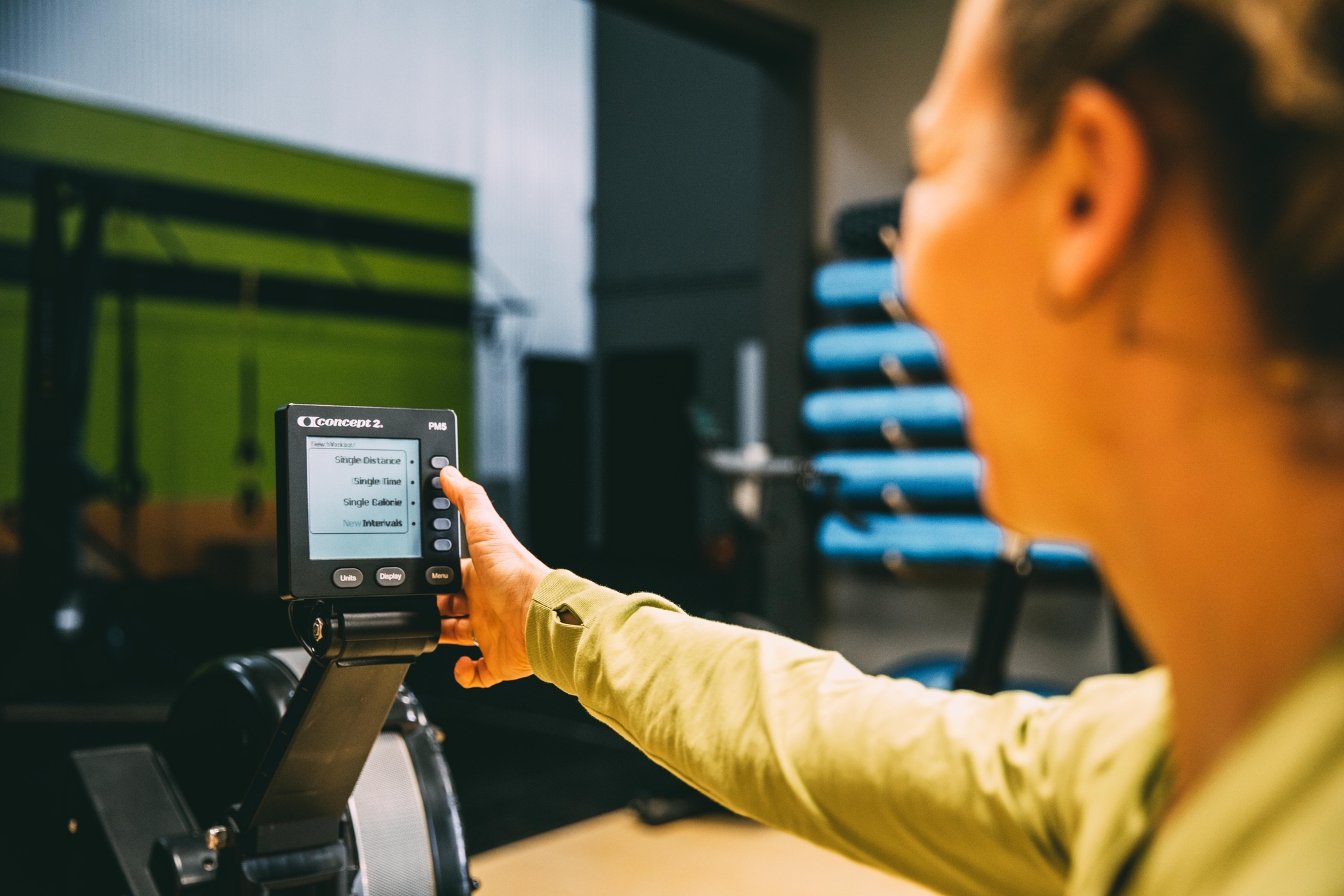 Woman using the PM5 on a RowErg