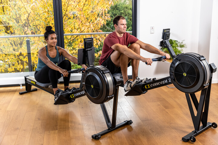 man and woman rowing on concept2 rowergs
